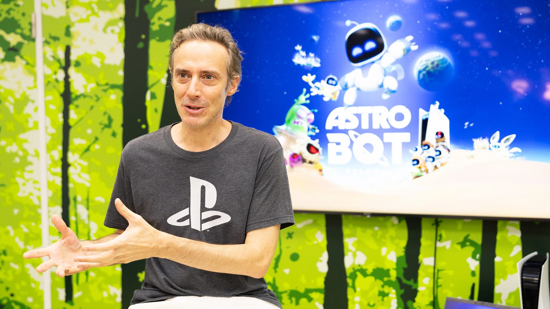 Team Asobi studio head Nicolas Doucet pictured beside Astro Bot artwork